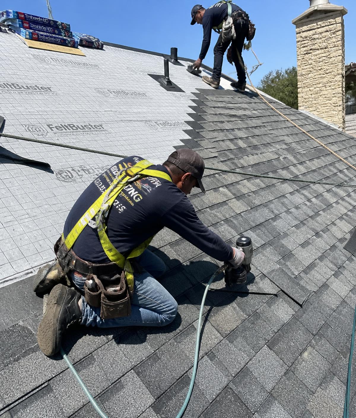 Lone Star Heritage Roofing crew installing shingles